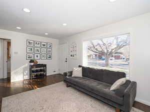 Living room with dark hardwood / wood-style flooring