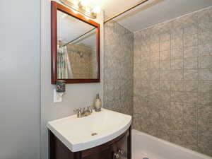 Bathroom featuring vanity and shower / bath combo