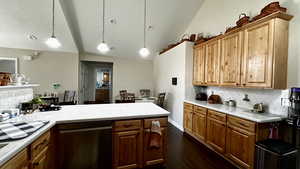 Kitchen featuring pendant lighting, black dishwasher, dark wood-type flooring, and decorative backsplash