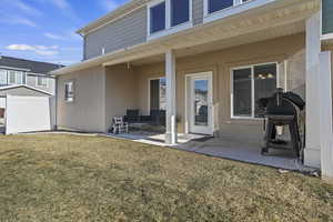 Back of property featuring a covered patio area.