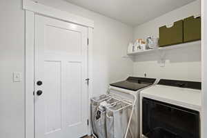 Laundry room featuring washer and clothes dryer