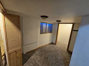 Unfurnished bedroom with dark carpet