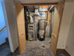 Utility room featuring water heater