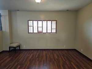 Unfurnished room featuring dark hardwood / wood-style flooring