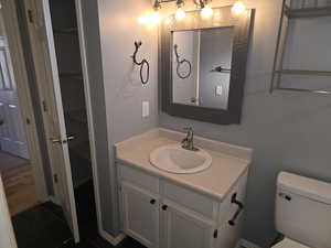 Bathroom with vanity, tile patterned floors, and toilet