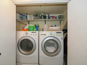 Clothes washing area featuring washer and dryer