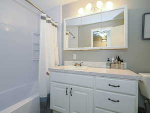 Bathroom with vanity and shower / bathtub combination with curtain