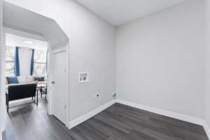 View of laundry room looking into living room