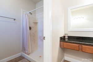 Bathroom featuring tile patterned floors and curtained shower