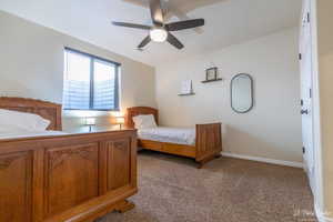 Carpeted bedroom with ceiling fan