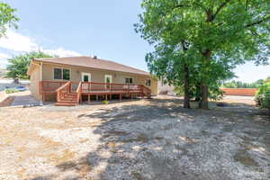 Back of house with a deck