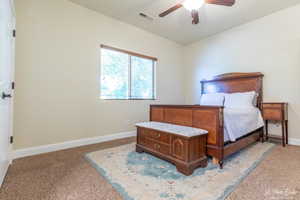 Bedroom with light carpet and ceiling fan