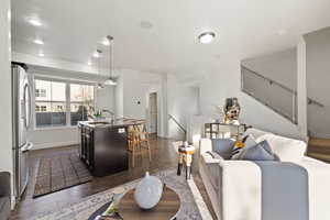 Living room with dark hardwood / wood-style flooring and sink