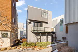 Rear view of property featuring a balcony