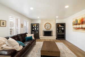 Living room featuring light hardwood / wood-style flooring and a fireplace