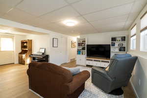 Living room featuring light wood-type flooring and open floor plan to second kitchen