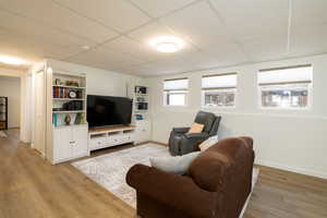 Living room with light hardwood / wood-style flooring and gas fireplace.