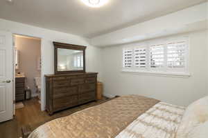 Primary Bedroom with dark wood-type flooring