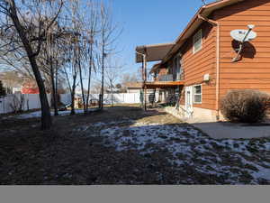 View of yard featuring basement entry, paved walk-way, and covered deck