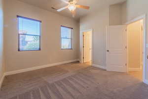 Unfurnished bedroom with light carpet and ceiling fan