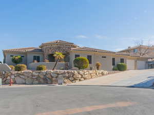 Mediterranean / spanish-style home featuring a garage