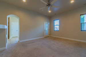 Spare room with ceiling fan and light carpet