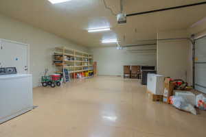 Garage with washer / clothes dryer and a garage door opener