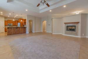 Unfurnished living room with light tile patterned flooring and ceiling fan