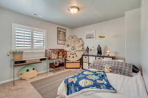 Carpeted bedroom with a textured ceiling