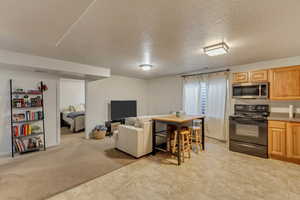 Carpeted living room featuring a textured ceiling