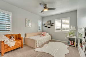 Bedroom featuring light carpet and ceiling fan