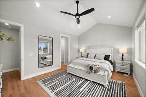 Bedroom featuring vaulted ceiling, ceiling fan, and light hardwood / wood-style flooring