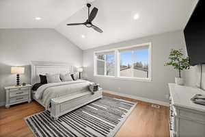 Bedroom featuring vaulted ceiling, ceiling fan, and light hardwood / wood-style floors