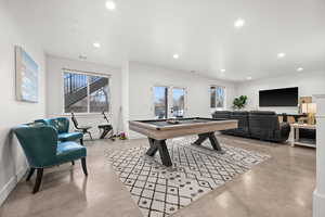 Playroom with plenty of natural light and billiards