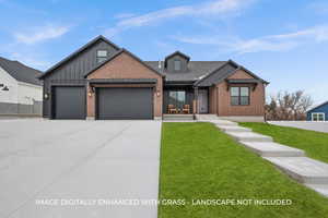 View of front of home featuring a garage and a front lawn