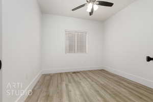 Spare room with ceiling fan and light wood-type flooring