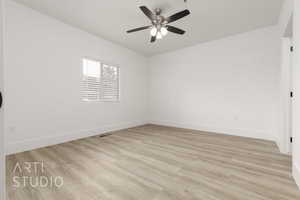 Spare room featuring ceiling fan and light hardwood / wood-style flooring