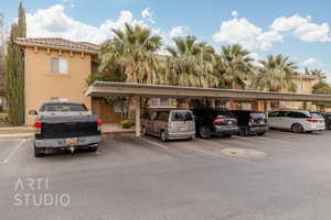 View of parking / parking lot featuring a carport