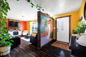 Entryway featuring a large fireplace and dark hardwood / wood-style floors