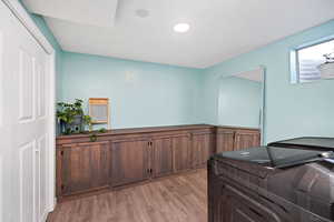 Laundry area featuring separate washer and dryer and light hardwood / wood-style floors