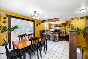 Dining room featuring light tile patterned floors and french doors.