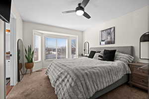 Carpeted bedroom with ceiling fan