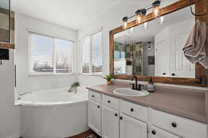 Bathroom featuring vanity and plus walk in shower