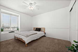 Carpeted bedroom with ceiling fan