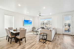 Living room with ceiling fan, a healthy amount of sunlight, and light hardwood / wood-style floors