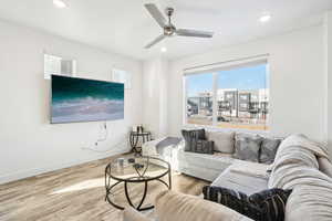 Living room with ceiling fan and wood-type flooring