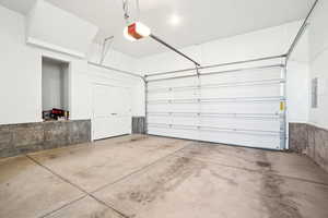 Garage with a garage door opener and electric panel