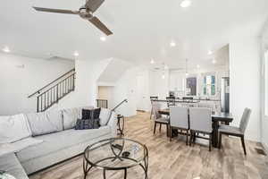 Living room with ceiling fan, sink, and light hardwood / wood-style flooring