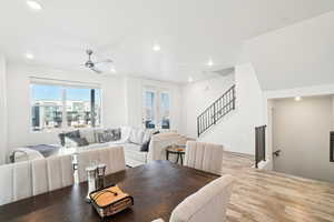 Dining space with ceiling fan and light hardwood / wood-style flooring