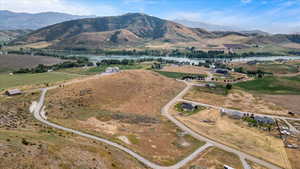 Property view of mountains with a water view and a rural view